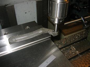  The waterjet process leaves a tapered edge, like plasma or flame cutting can. With the expansion link clamped up, we center on the bolt hole to bore it out.